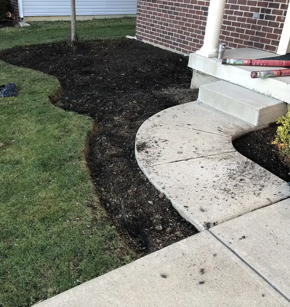 Freshly edged bed along a walkway after a cleanup