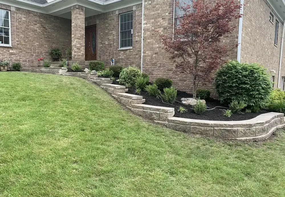 Tiered block retaining wall with planting bed in a front yard